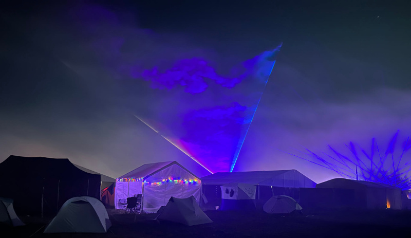 The WHY2025 camp site, with multiple laser beams above it